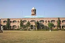 Long, two-story building with towerpunjab group of colleges