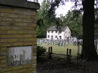 Entrance gate, cemetery, and meeting house