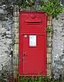 A close-up of the postbox set into a wall on the property