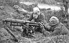 British Vickers machine gun crew wearing PH gas helmets with exhaust tubes