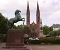 The Waterloo Obelisk in the Luisenplatz in Wiesbaden, with the St. Bonifatius Church in the background