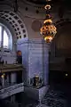 The rotunda of the Legislative building with chandelier and Roman fire pot.