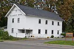 Photograph of the Willakenzie Grange Hall, a 2-story, gabled, wooden structure