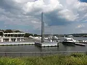 A decorative monolith standing along the riverwalk