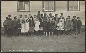 A group of school children outside Zealandia, Saskatchewan in 1910.